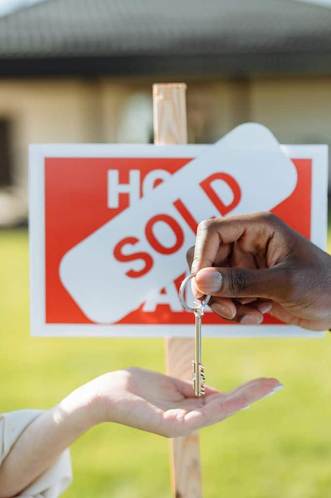 Close-up Photo of a Hands and a Key