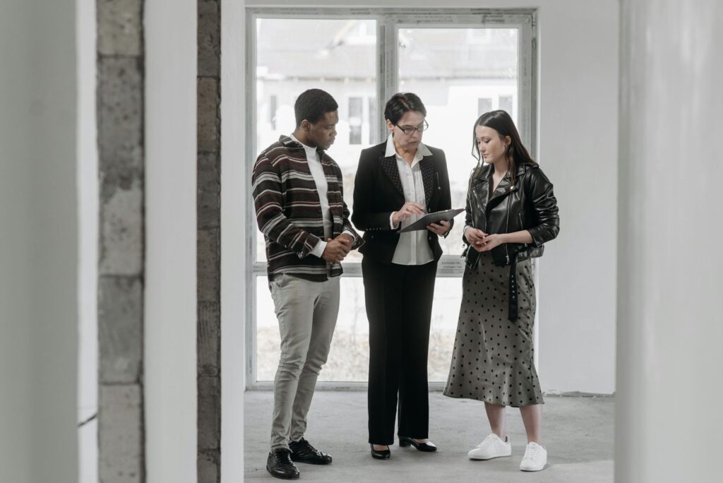 Man and Woman Talking with Real Estate Agent