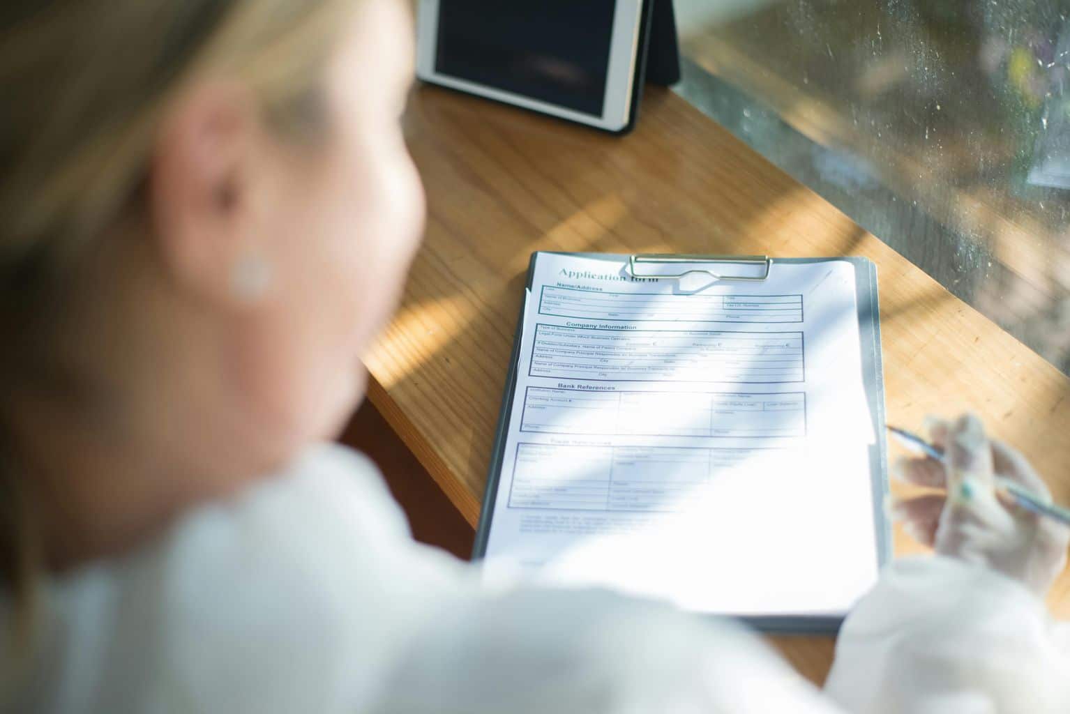 Woman Filling Out an Application Form