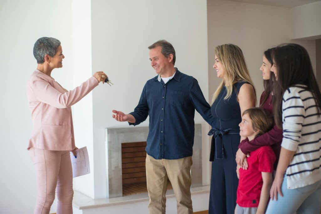 A Happy Family Talking to a Realtor