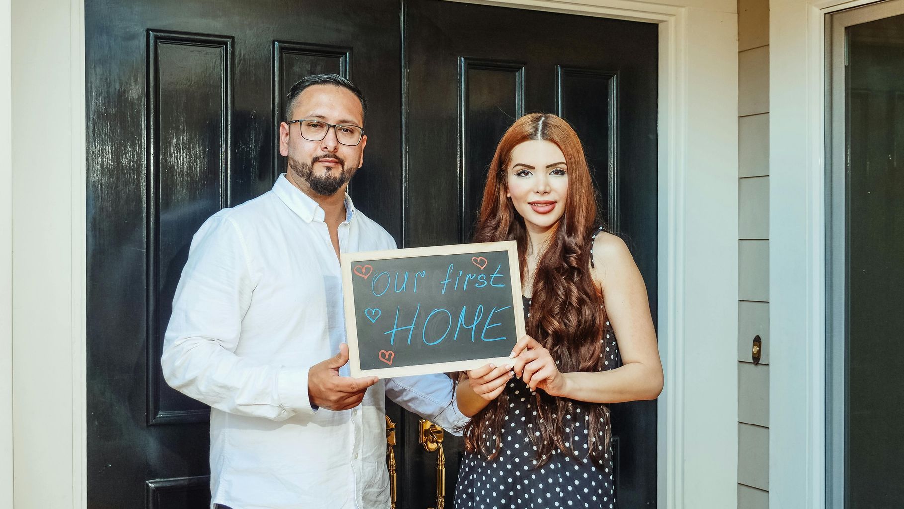 Couple Holding a Chalkboard