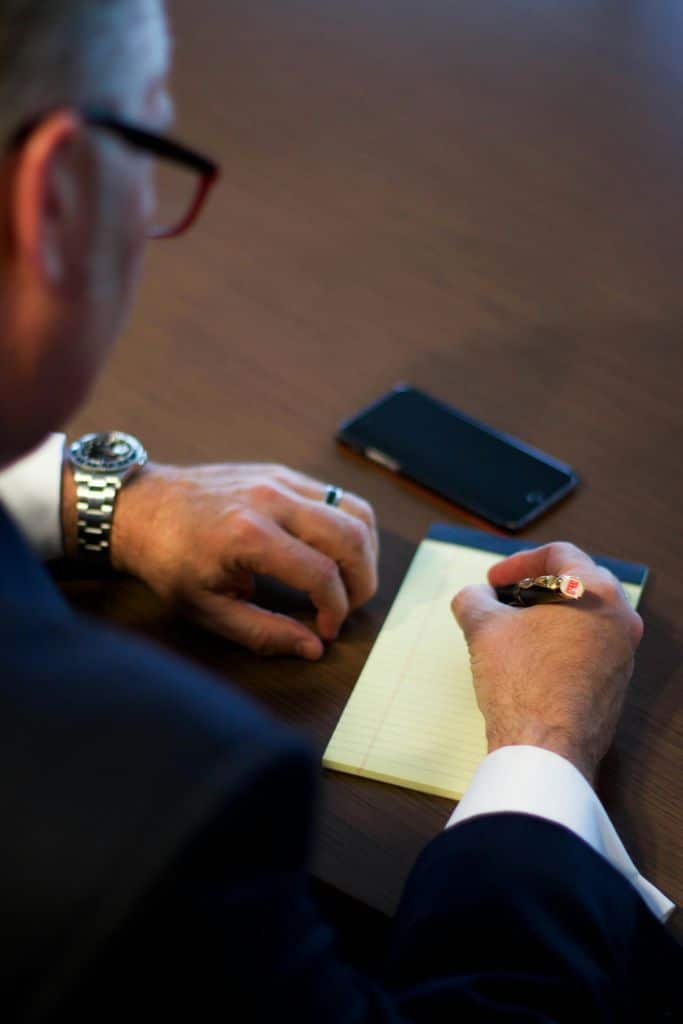 Person Writing Notes on White Ruled Paper