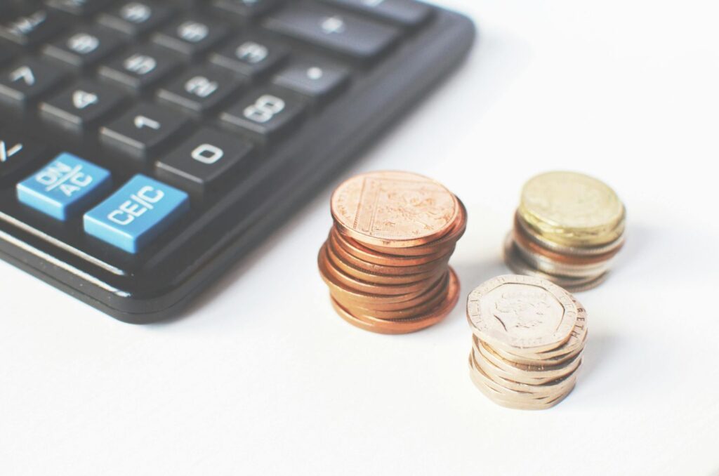 Gold-colored Coins Near Calculator