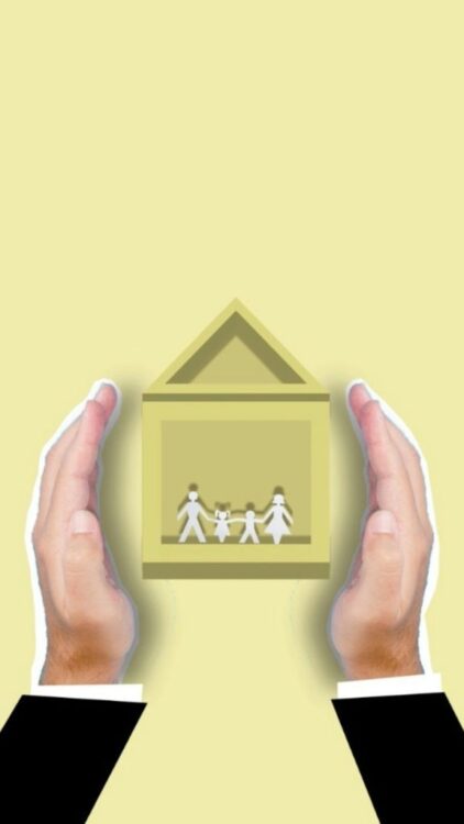 Creative image of cutout faceless person showing vector house image with family members inside