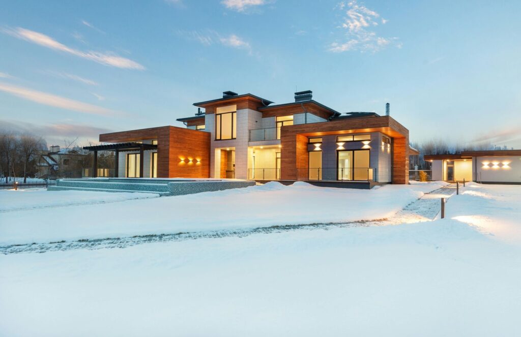 Illuminated cottage house in winter countryside