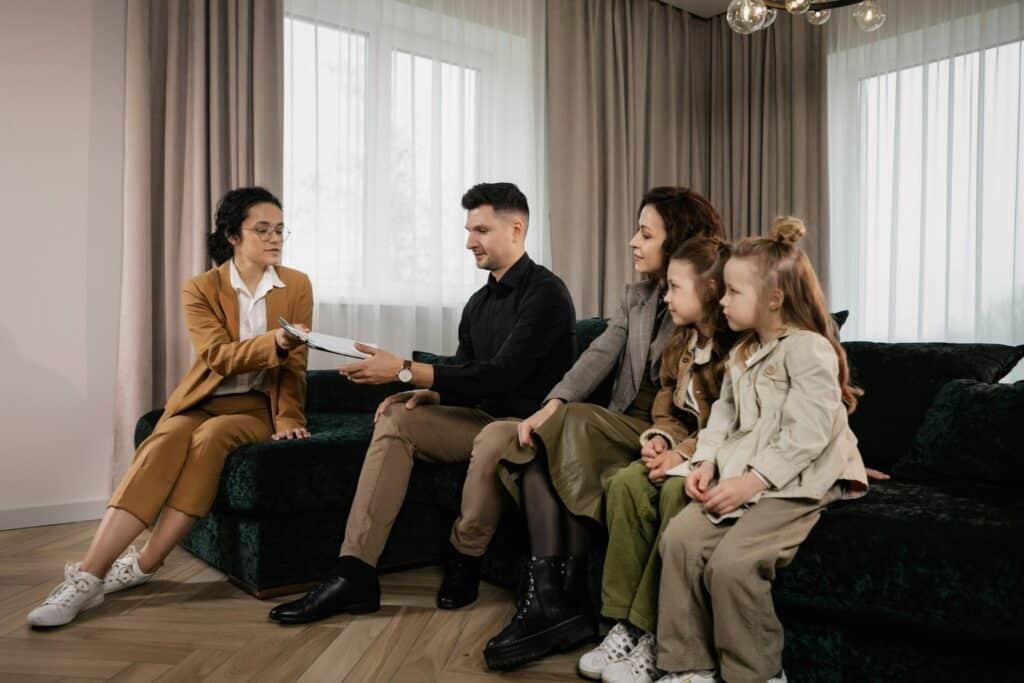 Family Sitting on Velvet Sofa