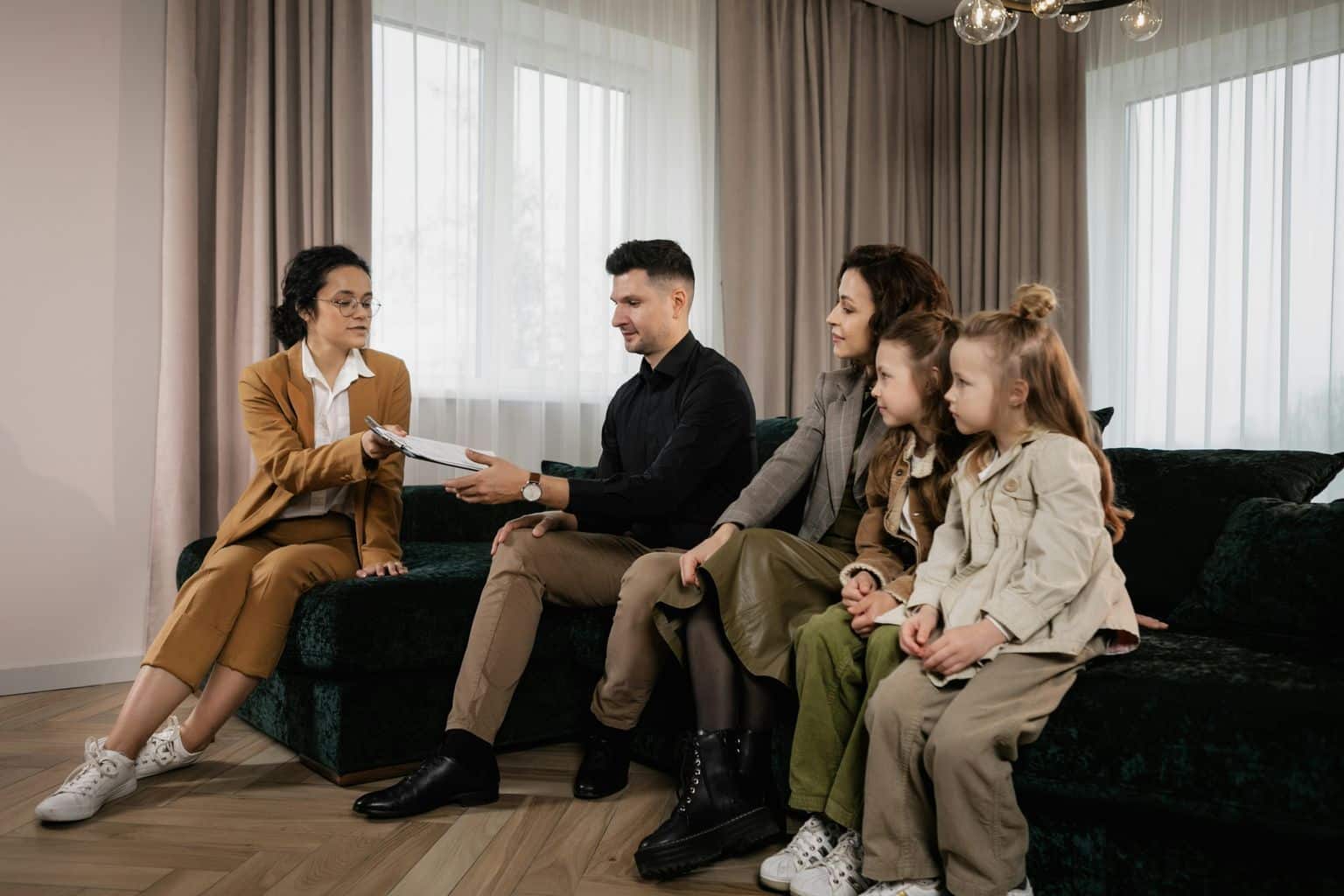 Family Sitting on Velvet Sofa