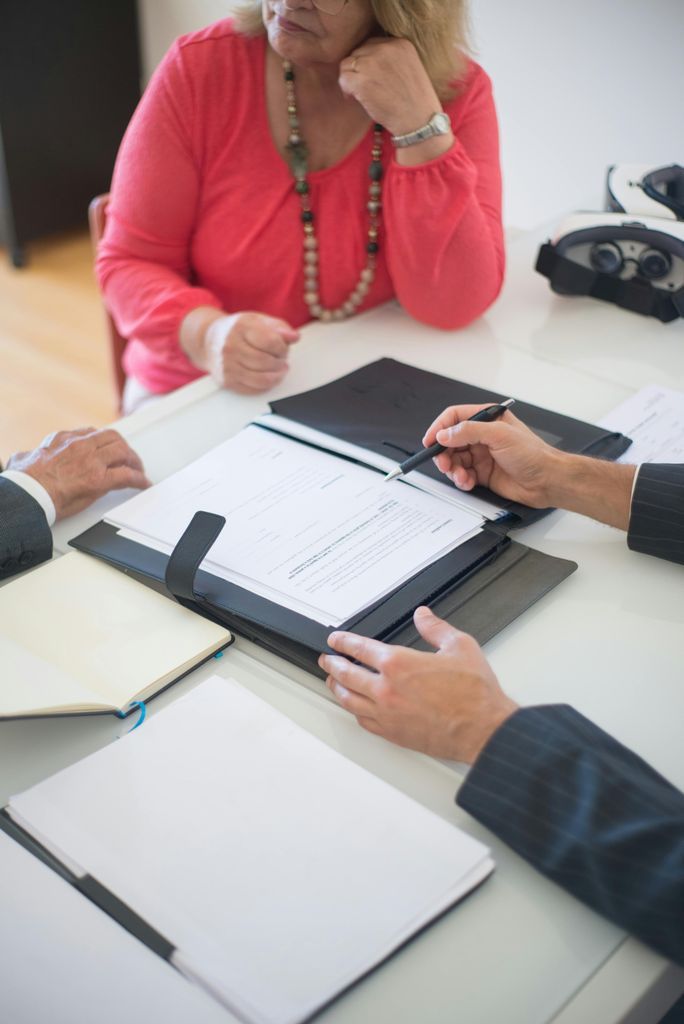 Person Discussing Real Estate Agreement of Home Mortgage to Senior Couple