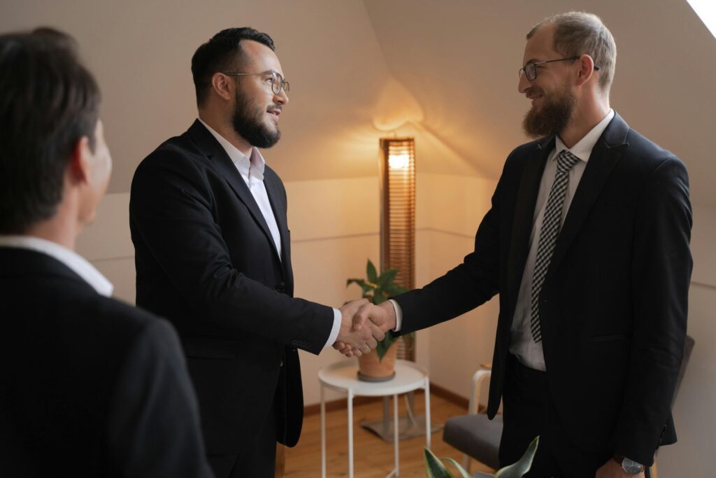 Two Men in Business Attire Handshaking