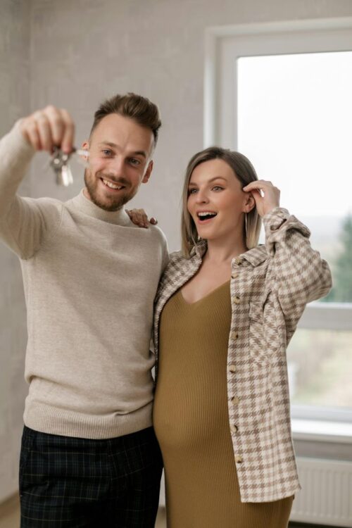 A Couple Holding the Keys to Their New Home